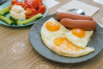morning breakfast of scrambled eggs with sausage and salad