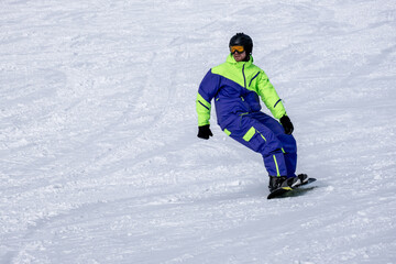 Fototapeta na wymiar Snowboarder on the slope. Opening of the ski season