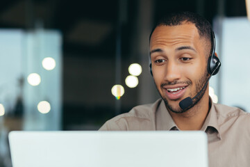 Close-up photo. Learning online. A young handsome African-American student is studying remotely...