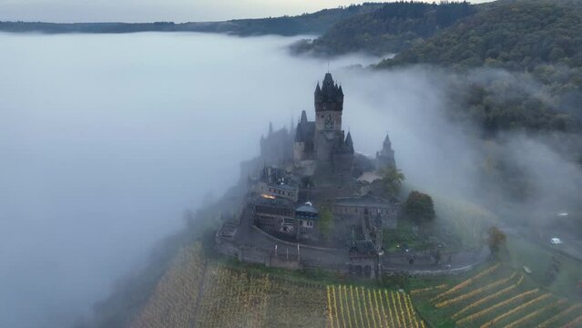 Beautiful 11 century Castle in Cochem, by the Mosel River, Rheinland-Palatinate, Germany. Aerial Drone Foggy Morning