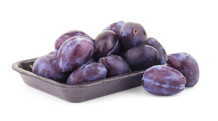 Three plums with leaves on white background
