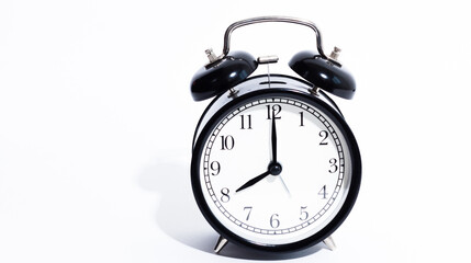 Old style alarm clock isolated on white