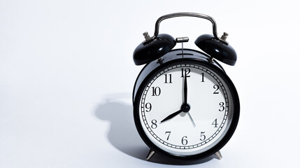 Naklejka premium Old style alarm clock isolated on white