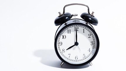 Old style alarm clock isolated on white