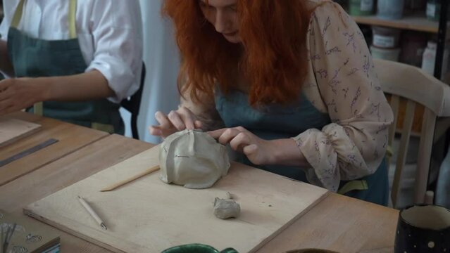 A potter crafts at the ceramic studio. Professional ceramist sculpts from clay.