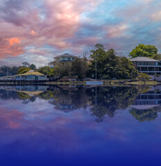 Fototapeta premium Sydney Harbour Australia at Sunset with the reflection of the Buildings and high rise offices of the City in the water