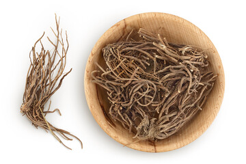Dried Valerian root in wooden bowl isolated on white background. Valeriana officinalis with full depth of field. Top view. Flat lay - obrazy, fototapety, plakaty