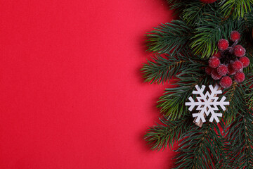 beautiful branches of the Christmas tree with cones and toys on a red background