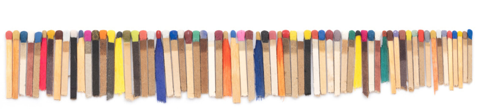 multicolored matchsticks on white paper