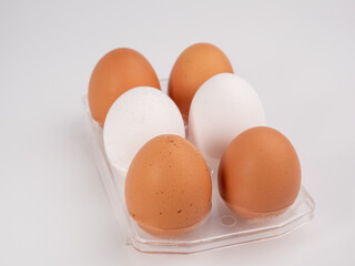 Chicken eggs on a white background. White and brown egg on a white background.