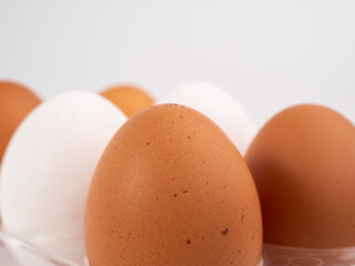 Chicken eggs on a white background. White and brown egg on a white background.