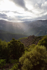Obraz premium Mountain Landscape Background. Sunset Sky with Sunrays. Near Dorgali, Sardinia, Italy.