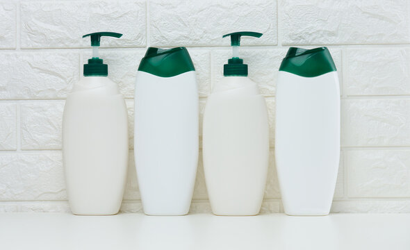 Empty plastic white bottles for cosmetics and other liquid substances on a white background.