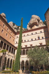 Vertical shot of the Abbey of Montserrat building in Barcelona, Spain against a blue sky