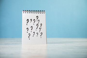 Notepad with question marks