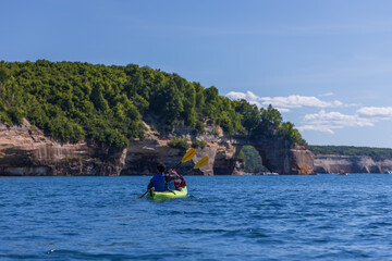 Fototapeta na wymiar Kayakers at Lover's Leap rock arch in Lake Superior at Pictured Rocks National Lakeshore, Upper Peninsula, Michigan, USA
