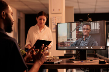 Fototapeta na wymiar African american man talking with executive manager on videoconference, startup strategy discussion on videocall. Company teamleader speaking on teleconference, coworkers online meeting