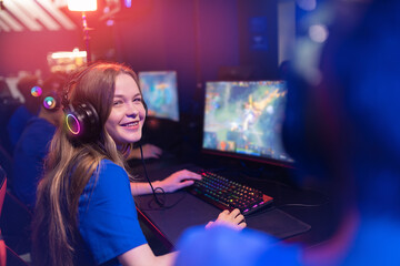 Professional gamer of team computer players, happy woman play online video games, neon color, soft...