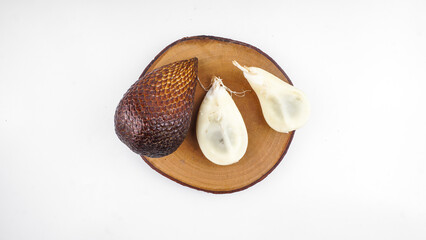 Salak fruit known as snake fruit native from Java island served on wooden board.