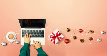 Christmas ornaments with person using a laptop computer - overhead view