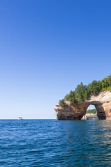 Boat next to Lover's Leap rock arch in Lake Superior at Pictured Rocks National Lakeshore, Upper Peninsula, Michigan, USA
