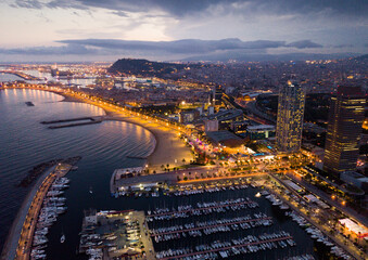 Barcelona seashore on Mediterranean in night lights, aerial view