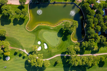 Golf field with green grass and trees, Aerial top view