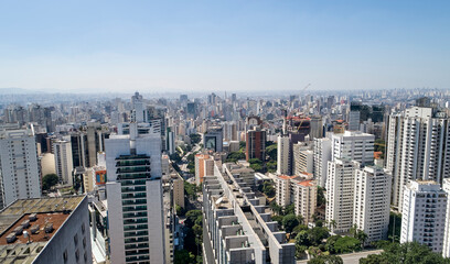 Fototapeta na wymiar Aerial view of the urban landscape of the Sao Paulo city. Commercial and residential buildings in downtown Sao Paulo, seen from Avenida Paulista. Brazil.