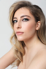 Obraz premium Vertical portrait of gorgeous young woman looking at the camera. Mock-up.