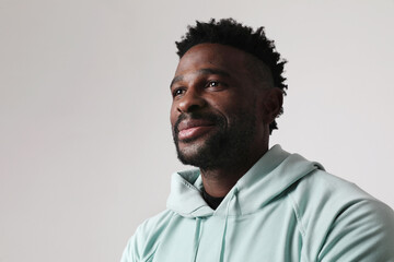Fototapeta premium Overjoyed dark skinned man wears casual outfit. Good emotions concept. Mock-up.