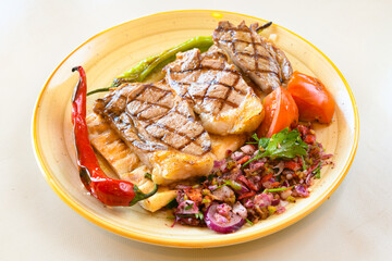 Beef steak grill with rice pilaf, fried potatoes, grilled pepper and tomatoes.Mix Platter with Beef rips, Cutlets, Potatoes and Sauces.