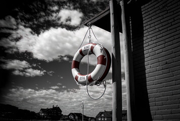 A lifebuoy is shown hanging vertically from a pole in Oesterstrand, Frederiksberg, Denmark. Generative AI