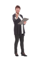 Side view of senior woman in glasses holding clipboard with paper sheet and making notes.