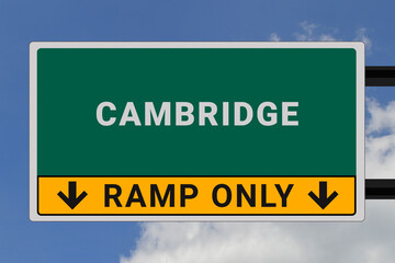 Cambridge logo. Cambridge lettering on a road sign. Signpost at entrance to Cambridge, USA. Green pointer in American style. Road sign in the United States of America. Sky in background