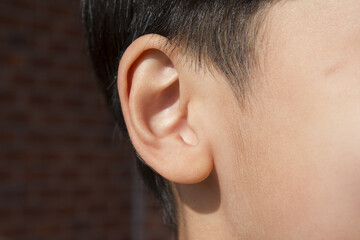 Ear of child or ear of boy.