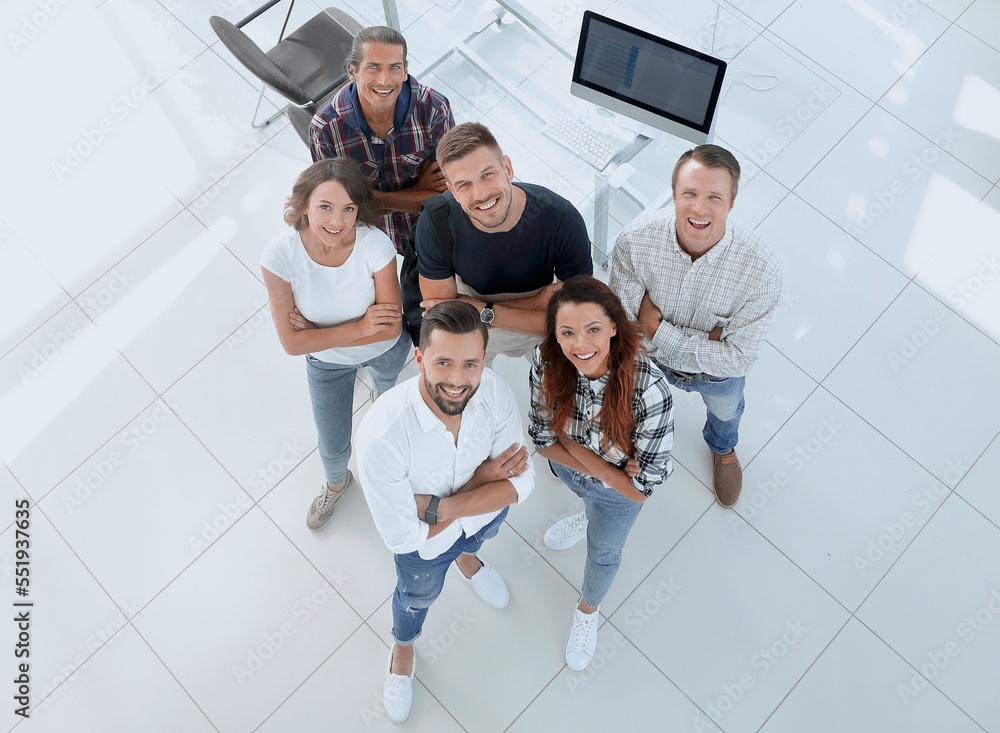 Poster young professionals standing near the desktop