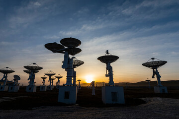 The silhouette of a radio telescope