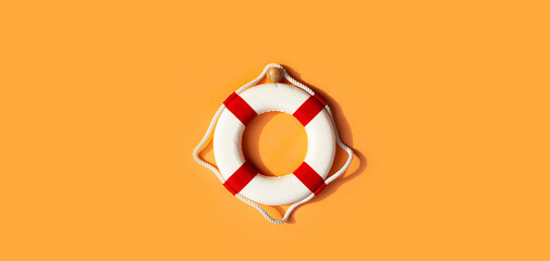 Lifebuoy on orange background. Copy space - obrazy, fototapety, plakaty