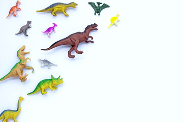 Plastic dinosaur toys on white background. Top view
