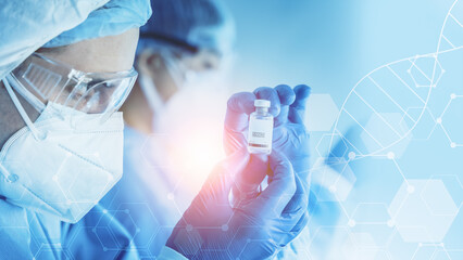 research scientist holding vaccine bottle in hand on modern clinical laboratory background
