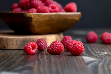 The harvest of red ripe raspberries is on the board