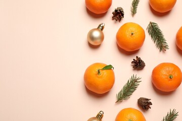 Composition with Christmas balls and tangerines on beige background, flat lay. Space for text