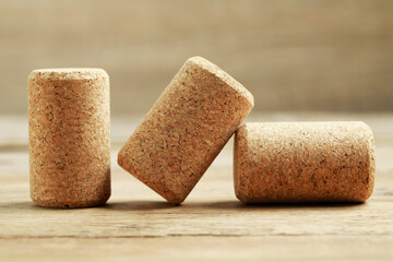 Corks of wine bottles on wooden table, closeup