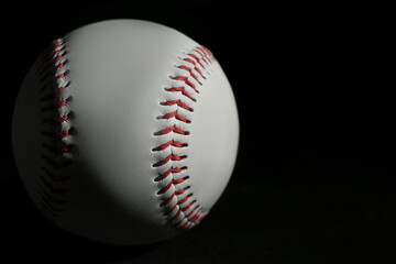 Baseball ball on black background, closeup with space for text. Sports game