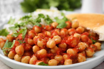 Plate with delicious chickpea curry on table, closeup