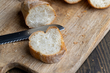 Sliced wheat baguette on a board