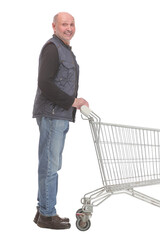 Smiling mature man holding shopping bags walking forward