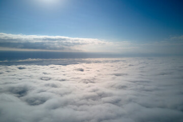 Aerial view from high altitude of earth covered with puffy rainy clouds forming before rainstorm