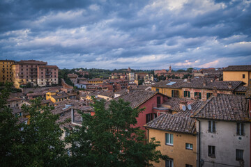 Fototapeta na wymiar Beautiful panoramic view of the historic city of Siena at daytime with an amazing cloudscape on an idyllic autumn evening, Tuscany, Italy. Long exposure picture. October 2022
