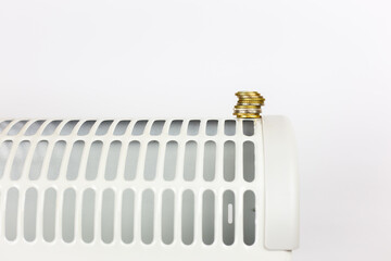 radiator or heater with coins. Concept of heating season, cold weather.